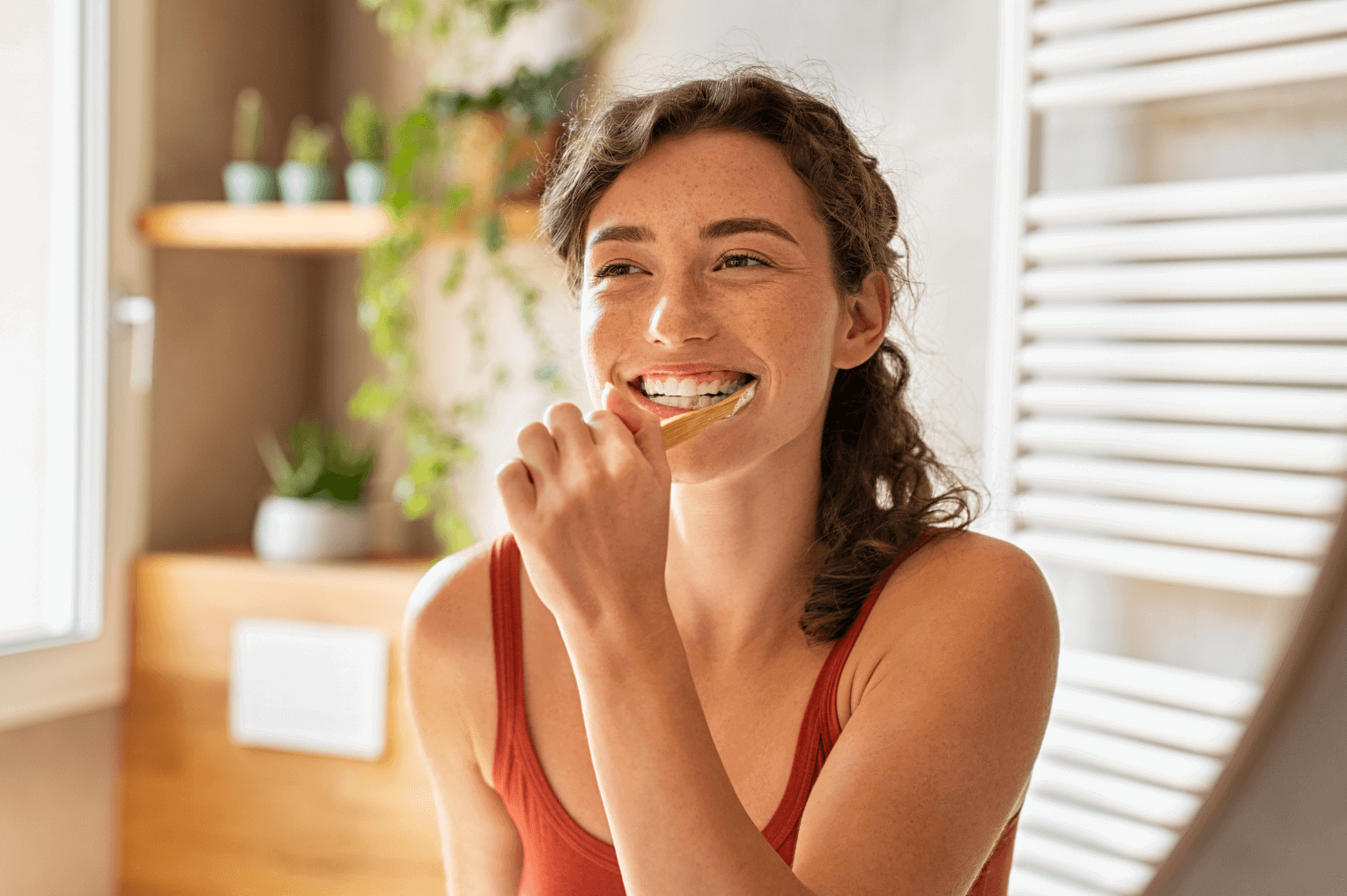 woman brushing her teeth to prevent gum disease