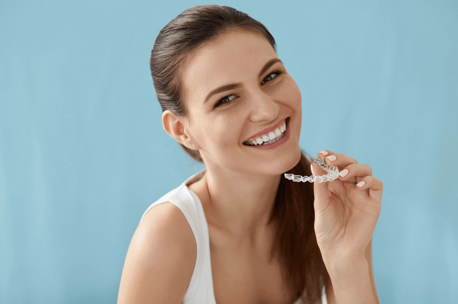 A woman holding her Invisalign braces in Marylebone