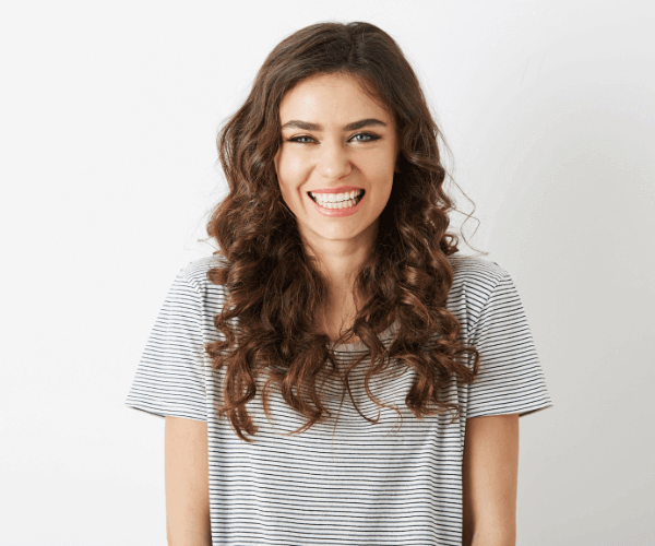 beautiful brunette woman smiling after invisalign braces at 19 Wimpole Street