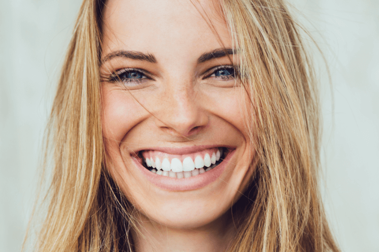 woman with straight teeth after braces treatment at 19 wimpole street dental practice