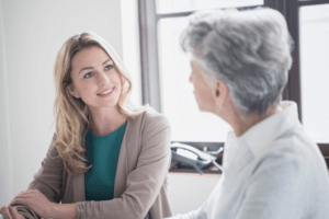 older woman discussing dental implants at 19 wimpole street dental practice